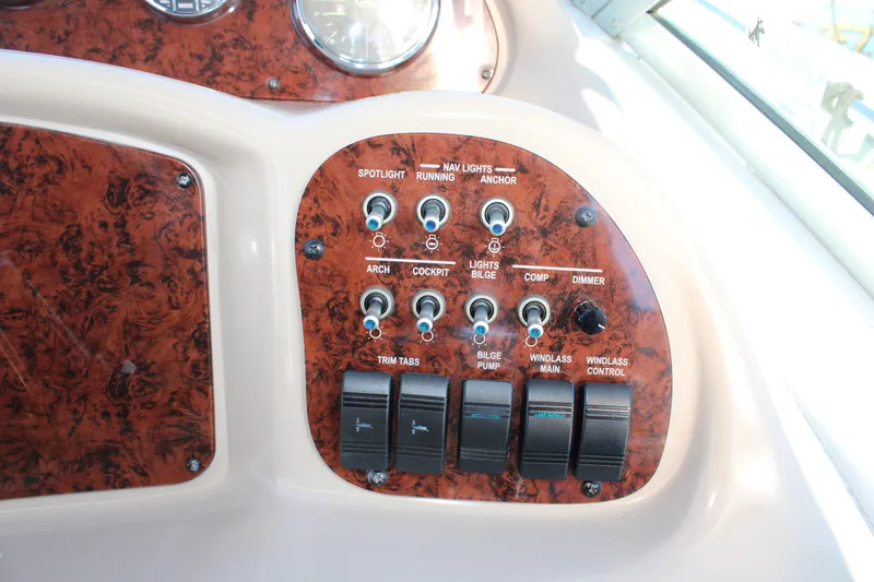 Slide: The Image of Control panel of a 2005 Sea Ray 340 Sundancer boat with various switches. - 20