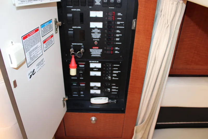 Slide: The Image of Electrical panel inside 2005 Sea Ray 340 Sundancer boat, showing switches and labels. - 26