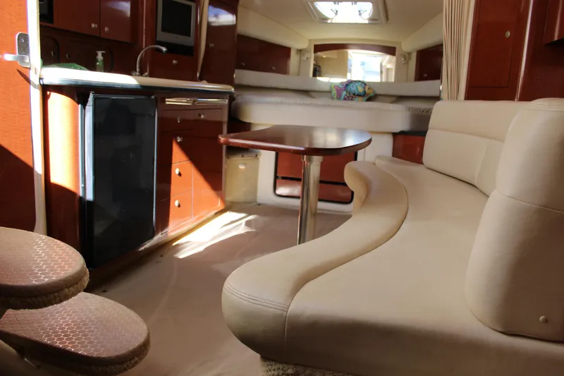 Slide: The Image of Interior of 2005 Sea Ray 340 Sundancer yacht with seating, table, and kitchenette. - 27