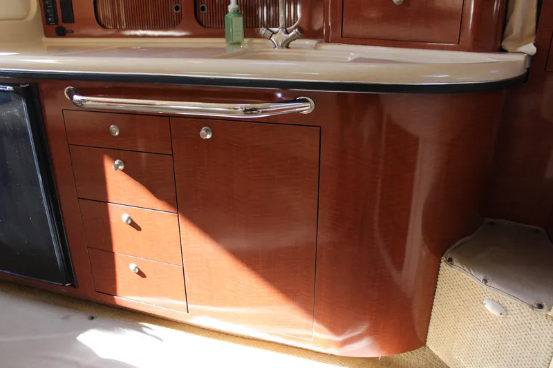 Slide: The Image of 2005 Sea Ray 340 Sundancer interior with wooden cabinetry and countertop. - 30
