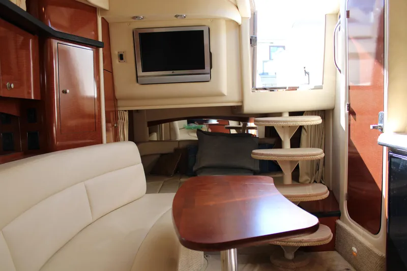 Slide: The Image of Interior of 2005 Sea Ray 340 Sundancer yacht with seating, table, and TV. - 31