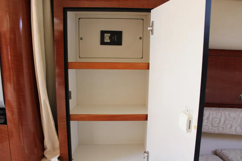 Slide: The Image of Open cabinet with shelves inside a 2005 Sea Ray 340 Sundancer boat. - 32