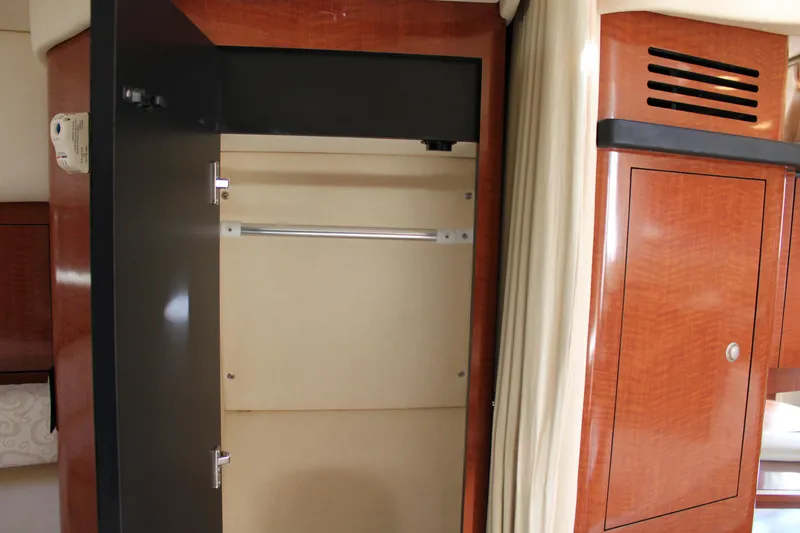 Slide: The Image of Interior closet of 2005 Sea Ray 340 Sundancer yacht, featuring wooden cabinetry. - 34
