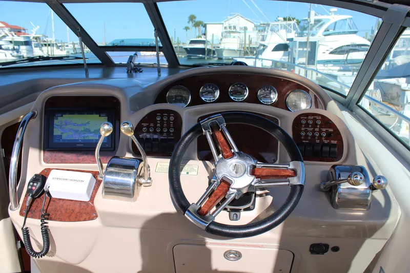 Slide: The Image of Helm of 2005 Sea Ray 340 Sundancer with gauges, steering wheel, and navigation system. - 4