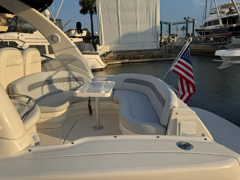 Slide: The Image of 2005 Sea Ray 340 Sundancer yacht with seating area and American flag at marina. - 42