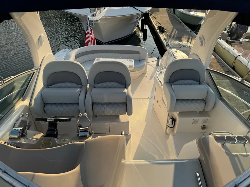 Slide: The Image of 2005 Sea Ray 340 Sundancer boat interior with plush seating and control panel. - 43