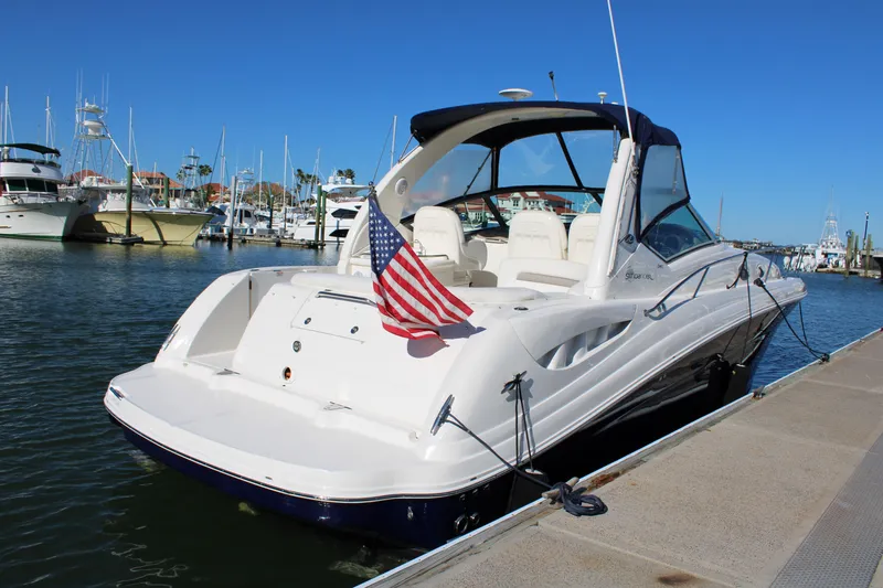 Slide: The Image of 2005 Sea Ray 340 Sundancer docked, featuring sleek design and American flag. - 7