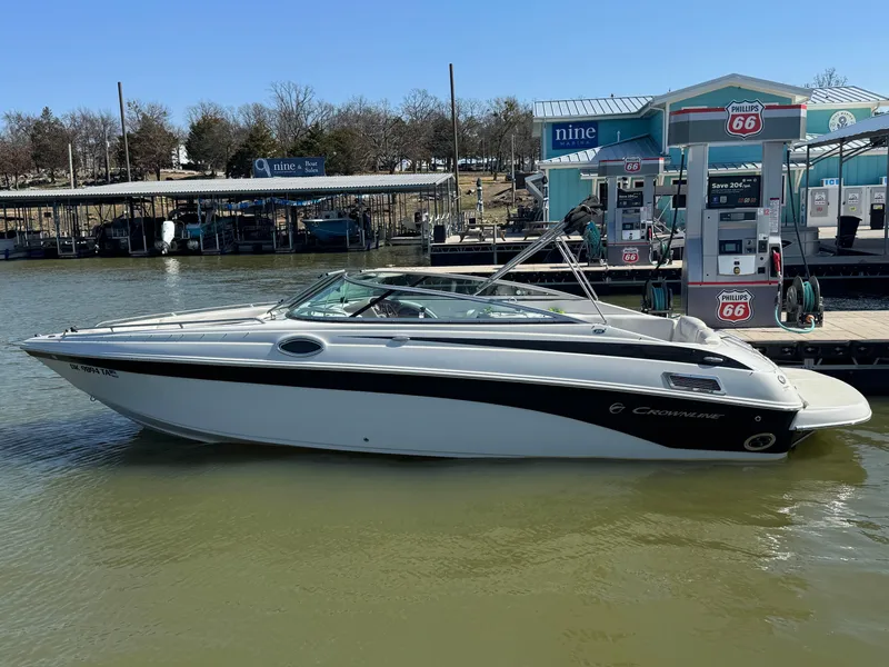 Slide: The Image of 2008 Crownline 270 BR boat docked at marina with fuel pumps in background. - 1