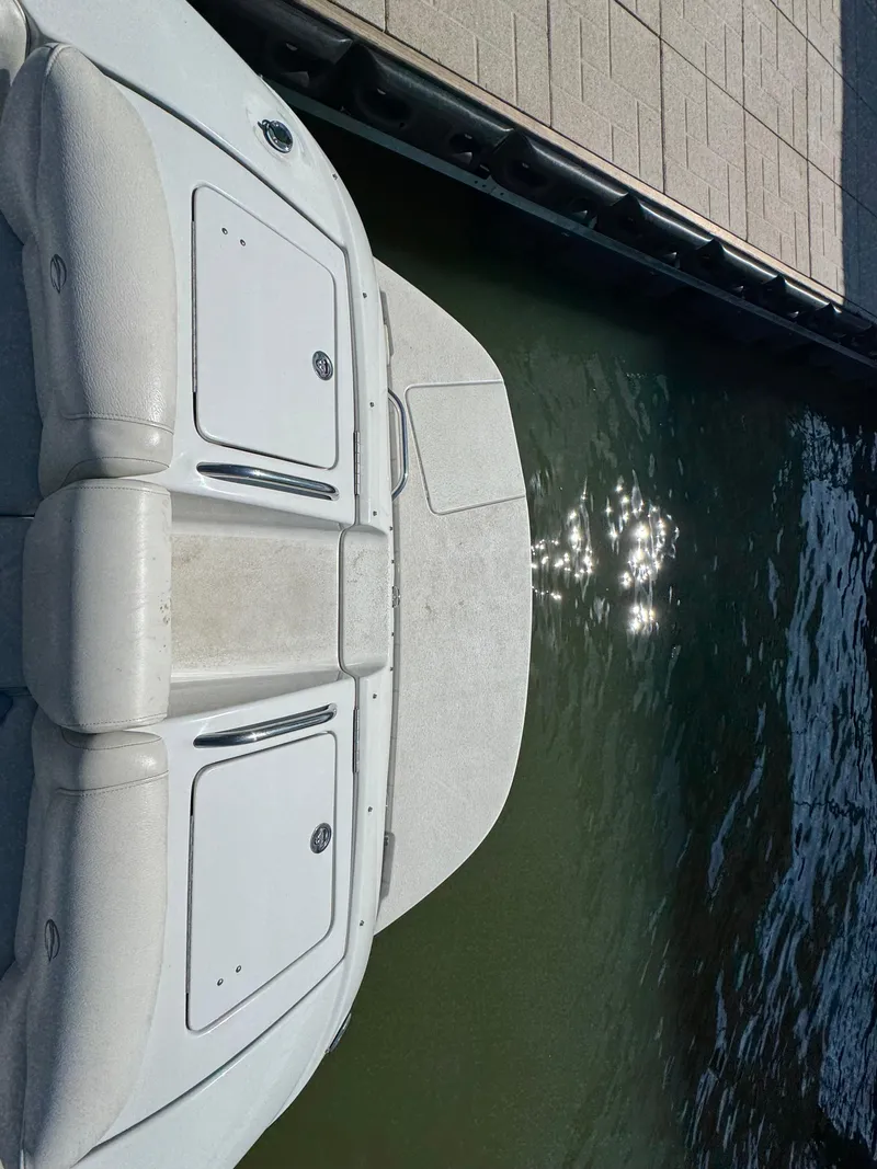 Slide: The Image of 2008 Crownline 270 BR boat docked by the water with sunlight reflections. - 12