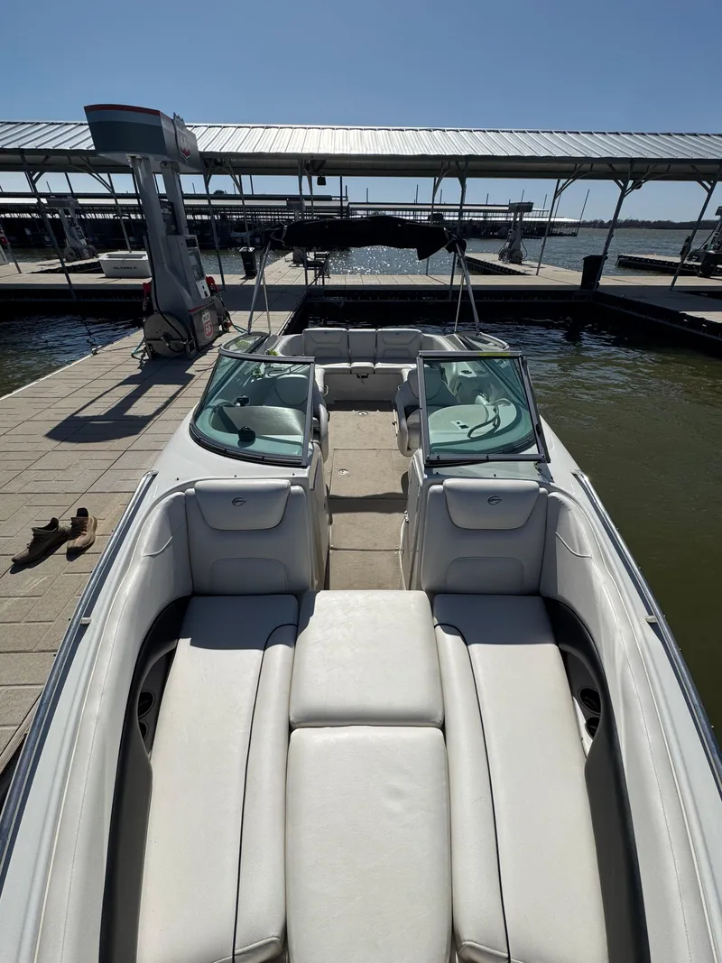 Slide: The Image of 2008 Crownline 270 BR boat docked, featuring spacious seating and sleek design. - 4
