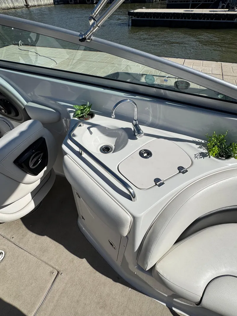 Slide: The Image of 2008 Crownline 270 BR boat interior with sink and seating area. - 6