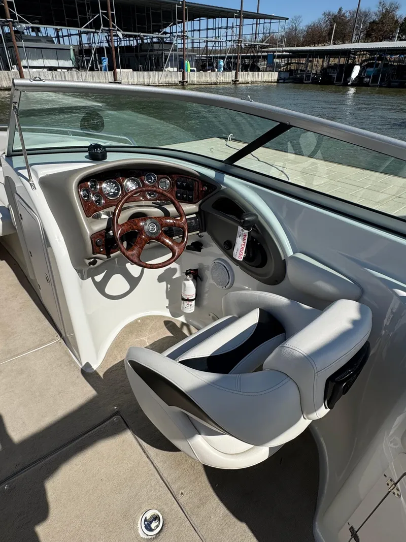 Slide: The Image of 2008 Crownline 270 BR boat cockpit with steering wheel and dashboard controls. - 9