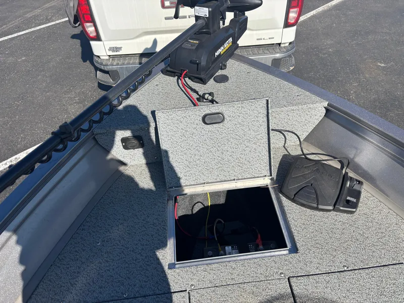 Slide: The Image of 2021 Crestliner 1650 Discovery SC boat with open storage compartment and trolling motor. - 5