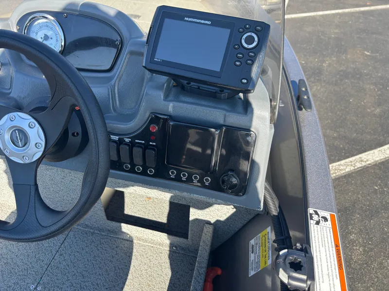 Slide: The Image of 2021 Crestliner 1650 Discovery SC dashboard with steering wheel and navigation display. - 6