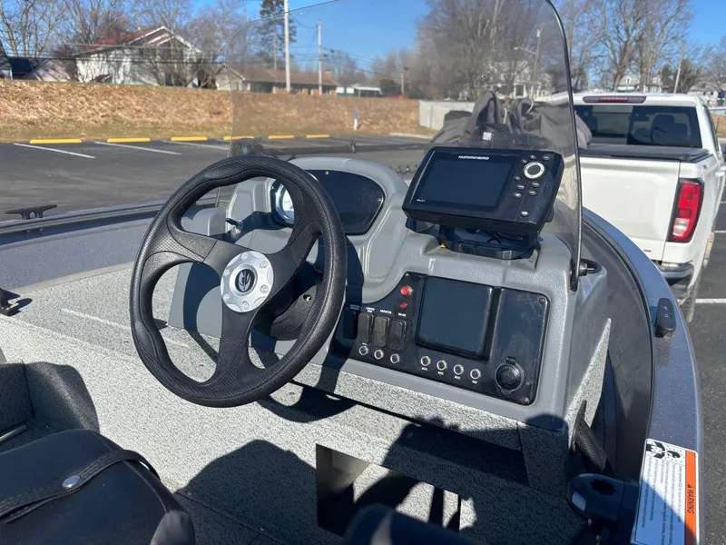 Slide: The Image of 2021 Crestliner 1650 Discovery SC boat dashboard with steering wheel and navigation system. - 9