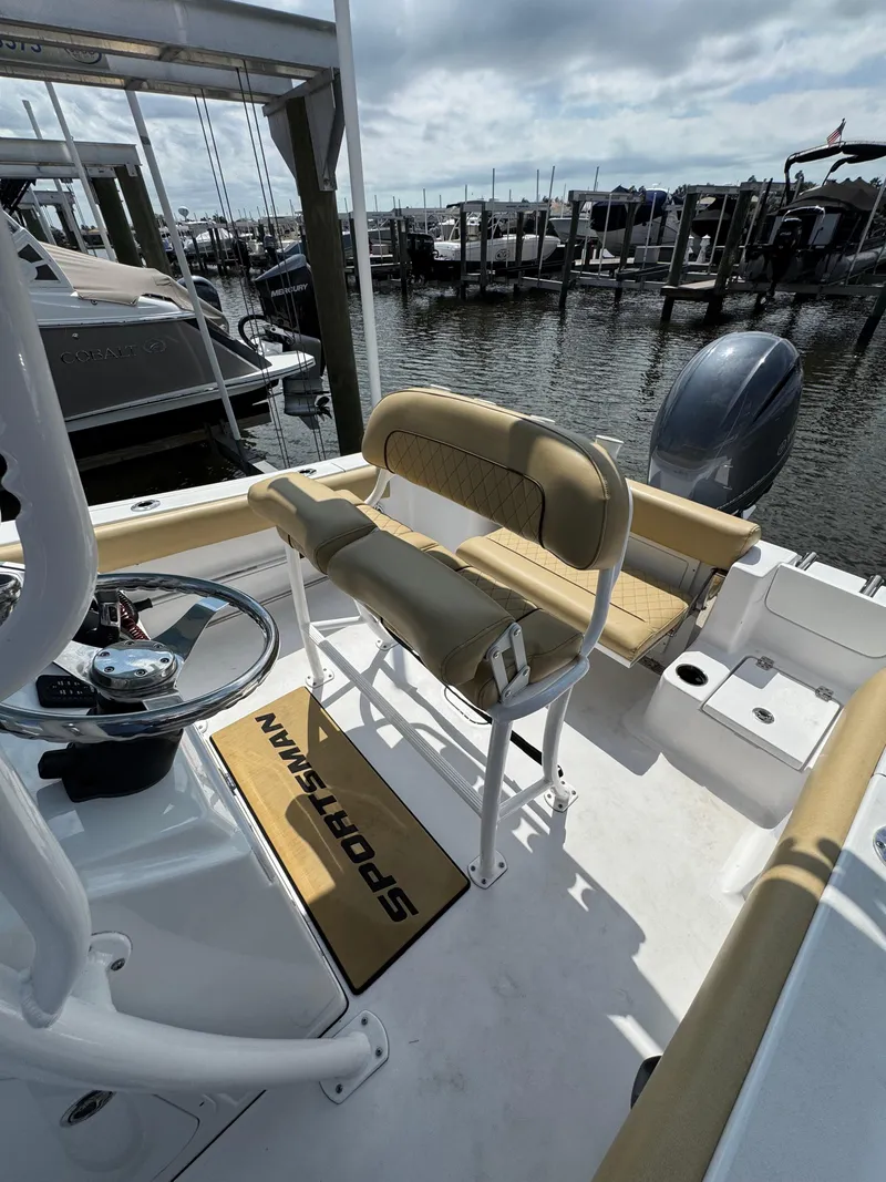 Slide: The Image of 2022 Sportsman Open 212 Center Console boat interior at a marina dock. - 10