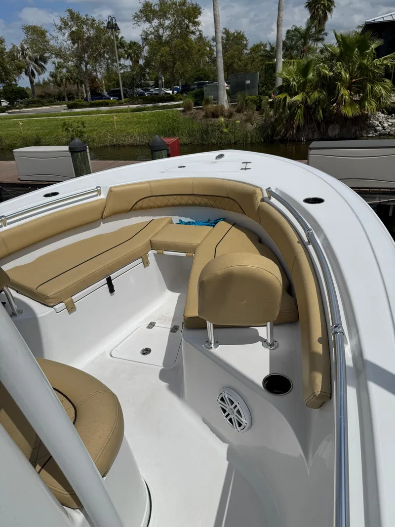 Slide: The Image of 2022 Sportsman Open 212 Center Console boat with tan seating and white deck. - 13