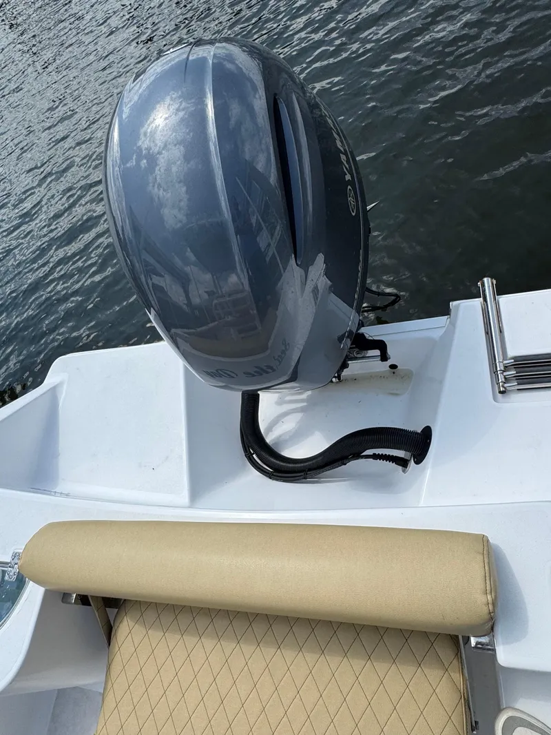 Slide: The Image of 2022 Sportsman Open 212 Center Console boat with outboard motor on water. - 15