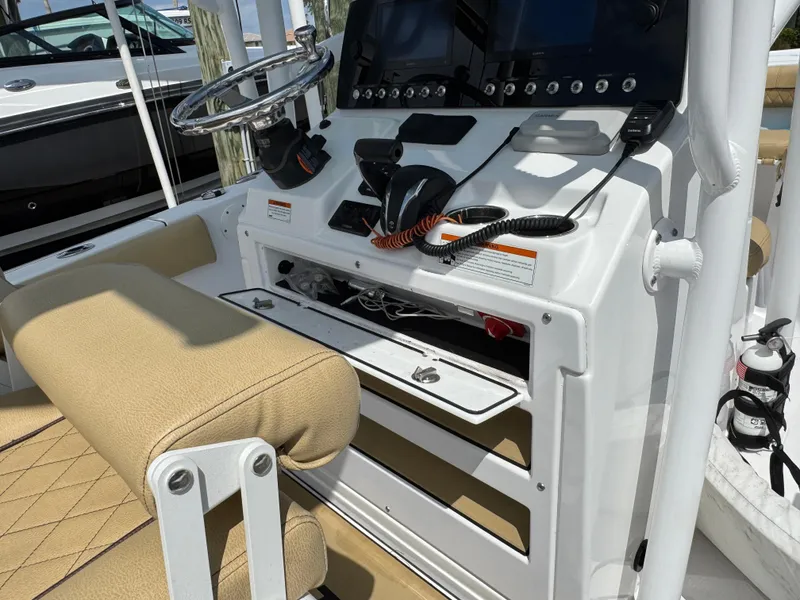 Slide: The Image of 2022 Sportsman Open 212 Center Console boat interior with steering wheel and controls. - 2