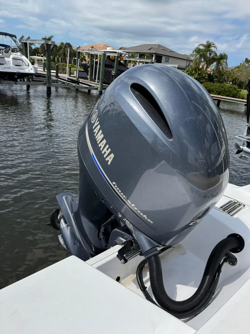 Slide: The Image of 2022 Sportsman Open 212 Center Console with Yamaha outboard motor in marina setting. - 20