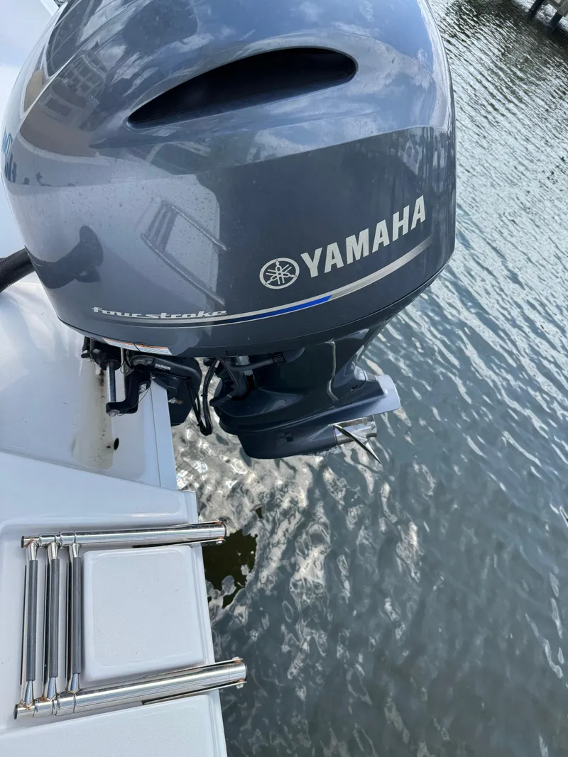 Slide: The Image of 2022 Sportsman Open 212 Center Console with Yamaha outboard motor on water. - 21