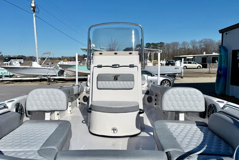 Slide: The Image of 2025 Carolina Skiff 21 Ultra Elite boat interior with gray cushioned seating and hexagonal pattern. - 10