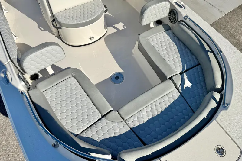 Slide: The Image of 2025 Carolina Skiff 21 Ultra Elite boat interior with cushioned seating and round table. - 11