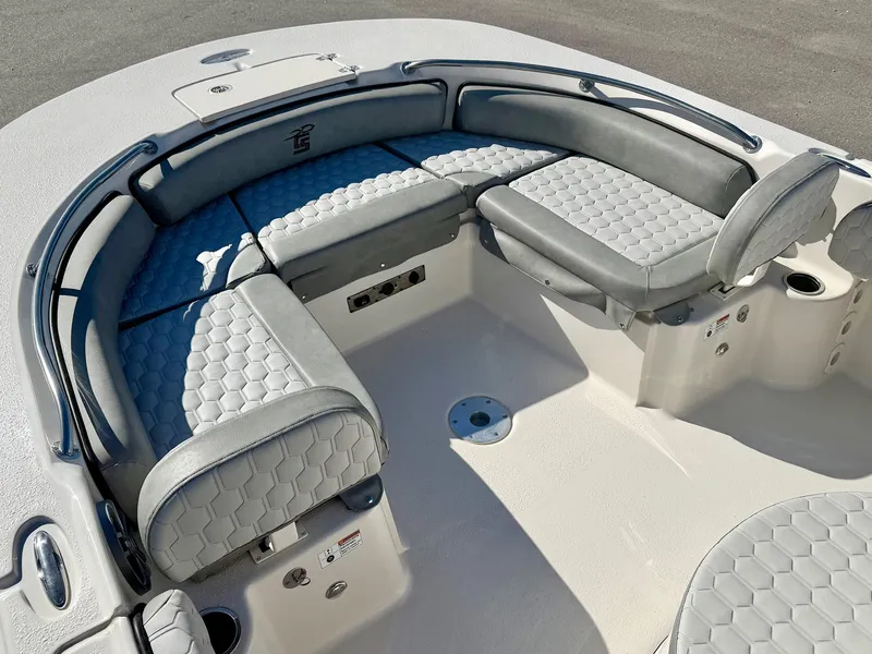 Slide: The Image of 2025 Carolina Skiff 21 Ultra Elite boat interior with cushioned seating and storage compartments. - 12