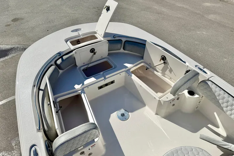 Slide: The Image of 2025 Carolina Skiff 21 Ultra Elite boat interior with open console storage and seating. - 15