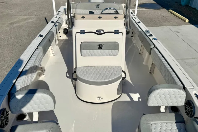 Slide: The Image of 2025 Carolina Skiff 21 Ultra Elite boat seating with gray upholstery and hexagonal pattern design. - 17