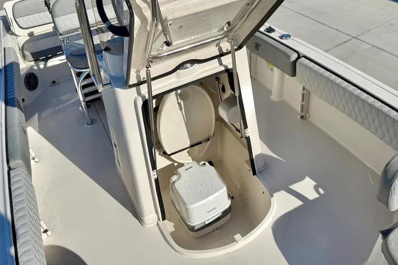 Slide: The Image of 2025 Carolina Skiff 21 Ultra Elite boat seating and storage compartment. - 18