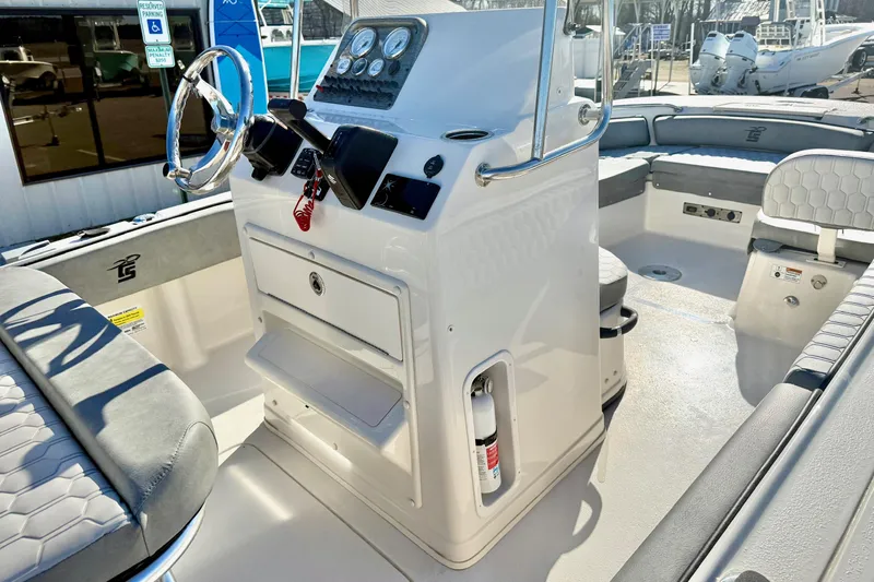 Slide: The Image of 2025 Carolina Skiff 21 Ultra Elite console storage with lock and red safety cord. - 20