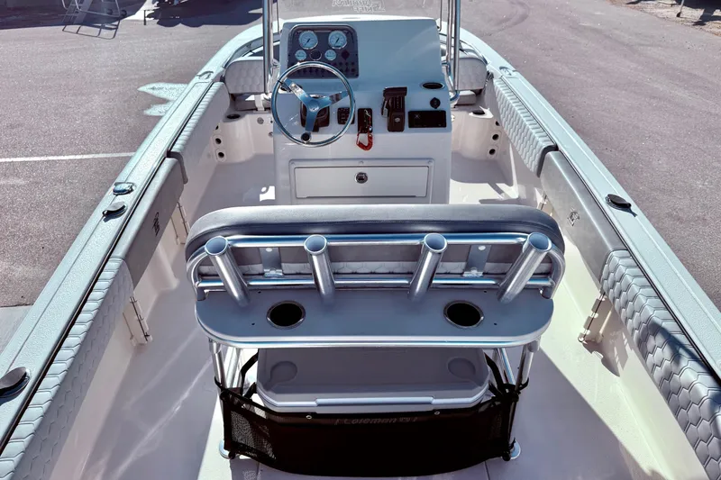 Slide: The Image of 2025 Carolina Skiff 21 Ultra Elite boat interior with portable toilet and storage compartment. - 25