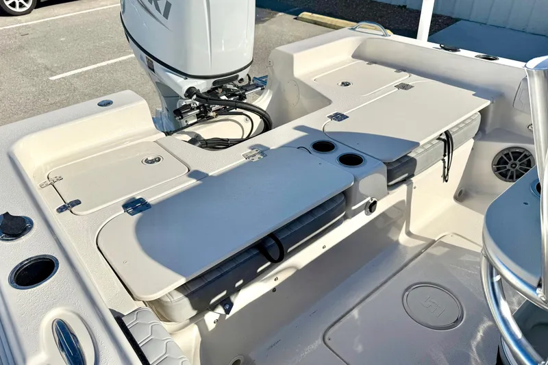 Slide: The Image of 2025 Carolina Skiff 21 Ultra Elite boat interior with open storage compartments and cup holders. - 28