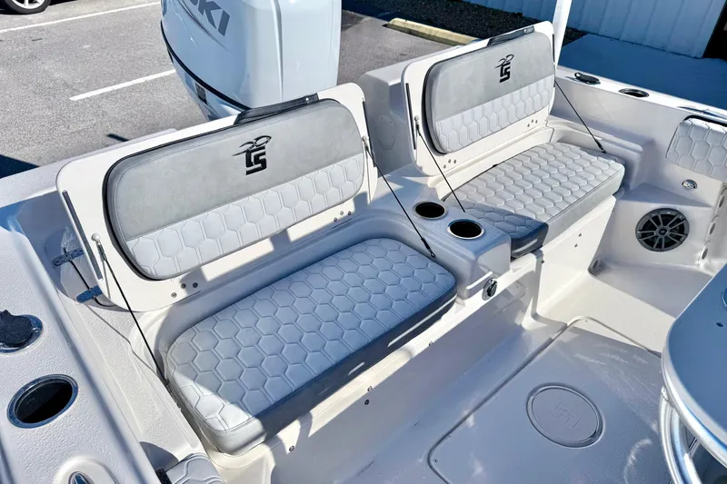 Slide: The Image of 2025 Carolina Skiff 21 Ultra Elite boat storage compartment with cup holders and seating. - 29