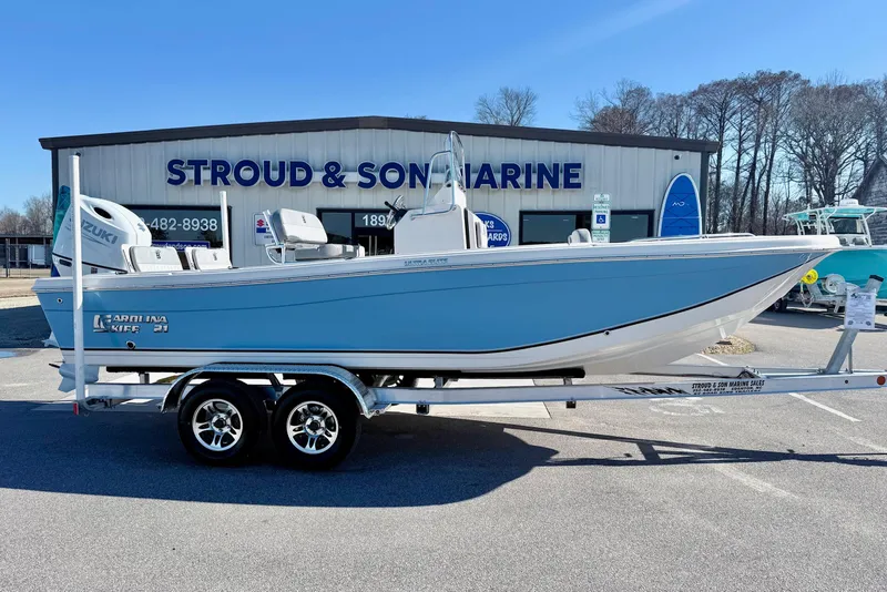 Slide: The Image of 2025 Carolina Skiff 21 Ultra Elite boat console with steering wheel and navigation controls. - 3
