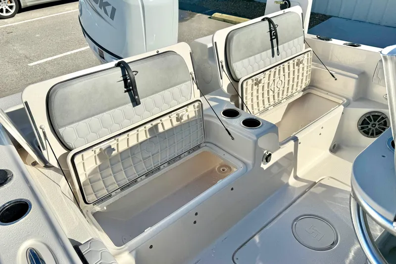 Slide: The Image of 2025 Carolina Skiff 21 Ultra Elite boat with Suzuki outboard motor, open storage compartments. - 30