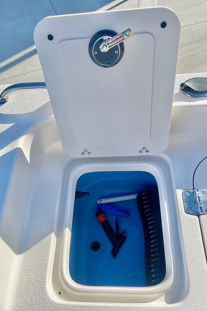 Slide: The Image of 2025 Carolina Skiff 21 Ultra Elite boat at dealership, featuring T-top and seating. - 33