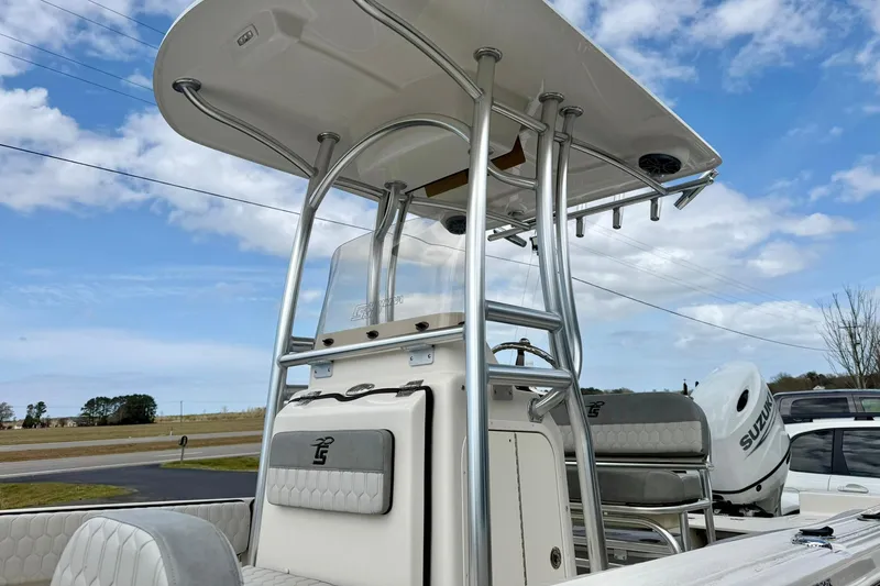 Slide: The Image of 2025 Carolina Skiff 21 Ultra Elite boat with T-top and Suzuki outboard motor. - 34