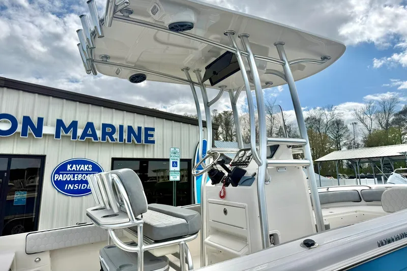 Slide: The Image of 2025 Carolina Skiff 21 Ultra Elite boat at a marine dealership under a cloudy sky. - 36
