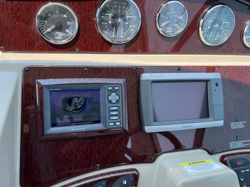 Slide: The Image of Dashboard of a 2011 Sea Ray 330 Sundancer with navigation and control instruments. - 10