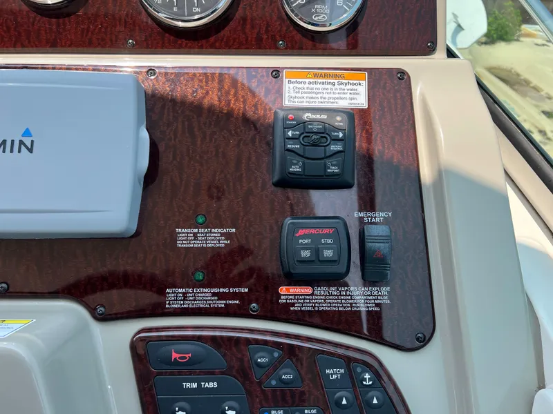 Slide: The Image of Control panel of a 2011 Sea Ray 330 Sundancer boat with various switches and gauges. - 12