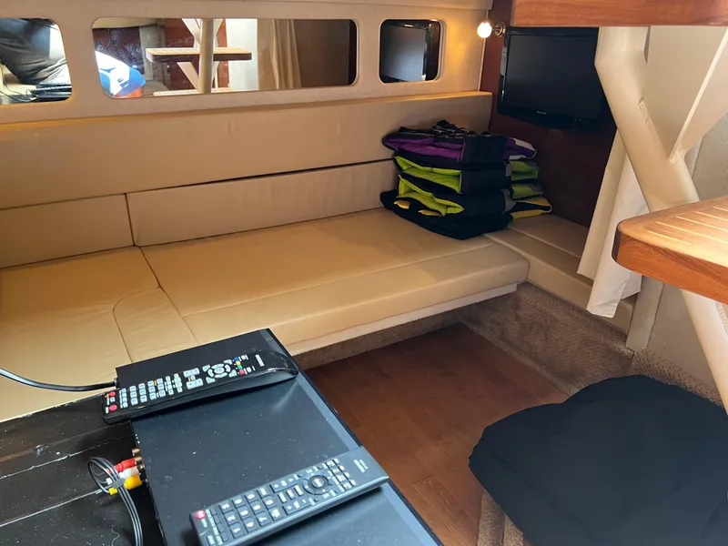 Slide: The Image of Interior of 2011 Sea Ray 330 Sundancer with beige seating and entertainment area. - 19