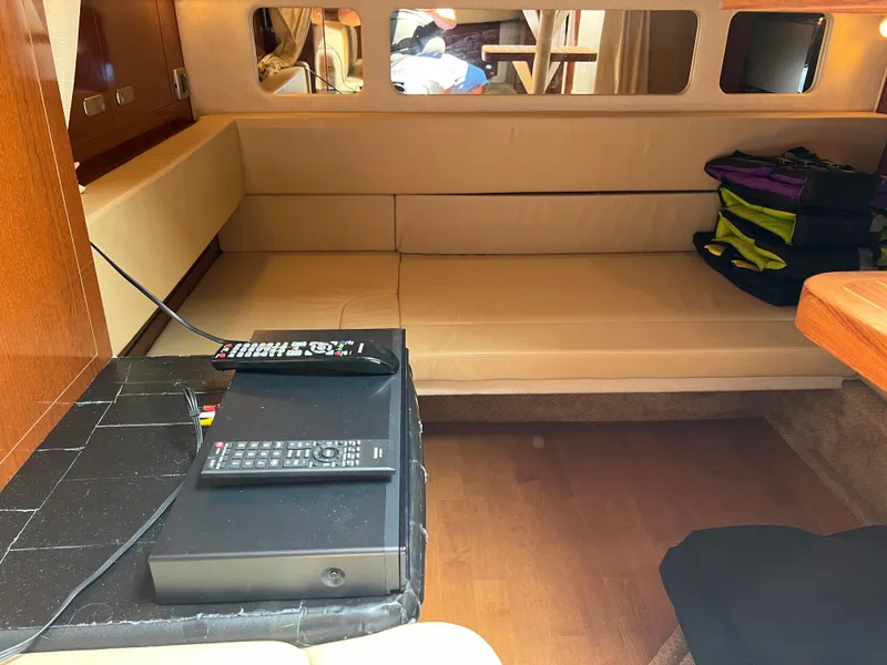 Slide: The Image of Interior of 2011 Sea Ray 330 Sundancer with beige seating and electronic equipment. - 20