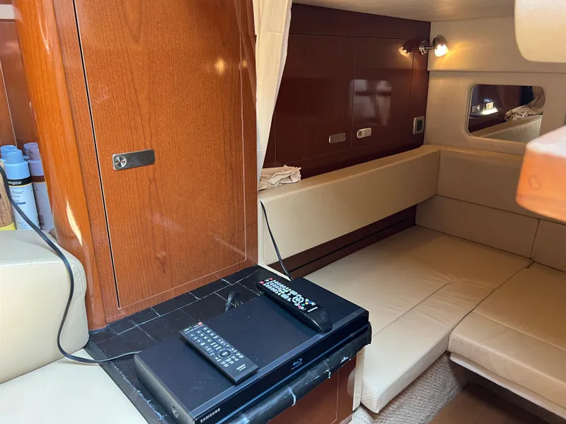 Slide: The Image of Interior of 2011 Sea Ray 330 Sundancer with beige seating and wooden cabinetry. - 21