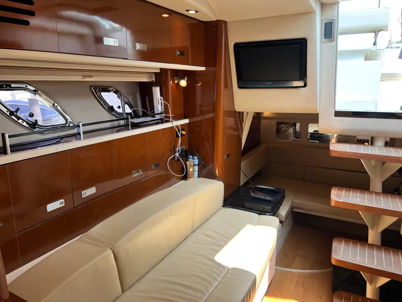 Slide: The Image of Interior of 2011 Sea Ray 330 Sundancer yacht with modern furnishings and entertainment system. - 27