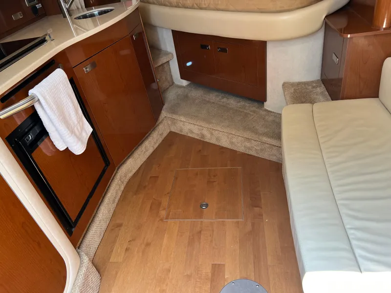 Slide: The Image of Interior of 2011 Sea Ray 330 Sundancer with wood flooring and compact kitchen area. - 29
