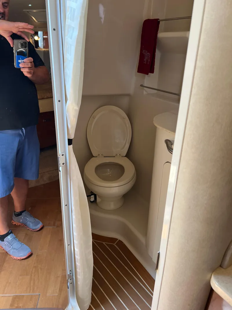 Slide: The Image of 2011 Sea Ray 330 Sundancer bathroom interior with toilet and sink. - 30