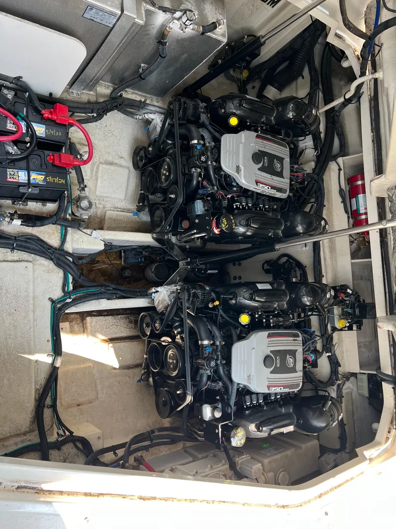 Slide: The Image of Engine compartment of a 2011 Sea Ray 330 Sundancer boat, featuring dual engines. - 34