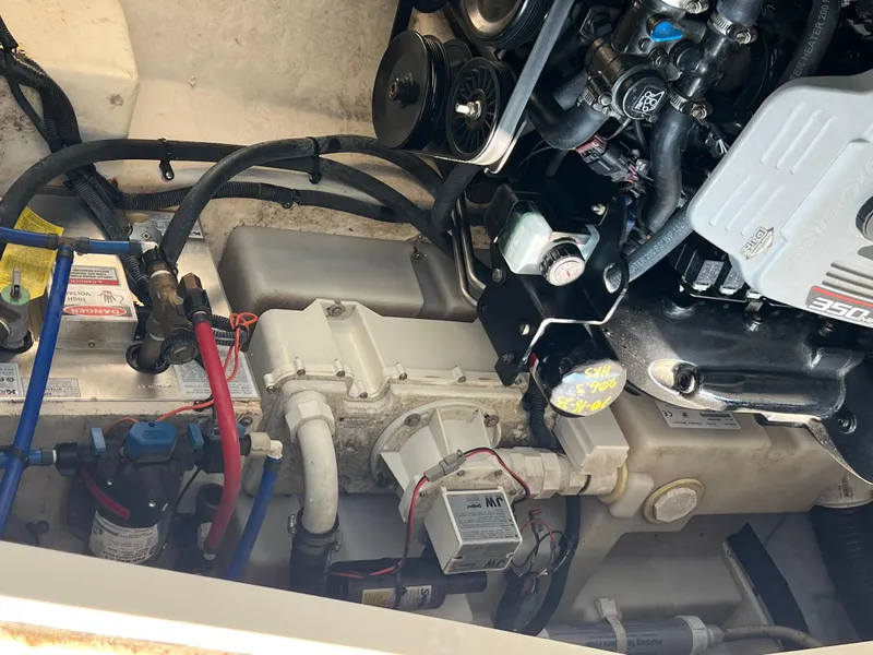 Slide: The Image of Engine compartment of a 2011 Sea Ray 330 Sundancer boat, showing mechanical components. - 36